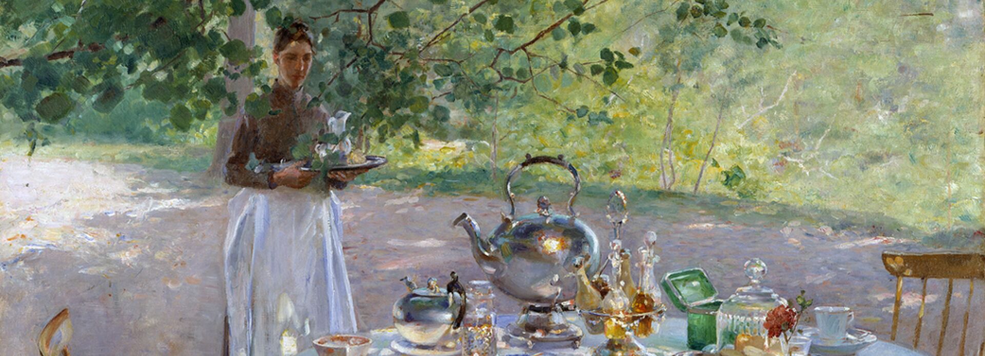 A table outside during summer time with a breakfast being served.