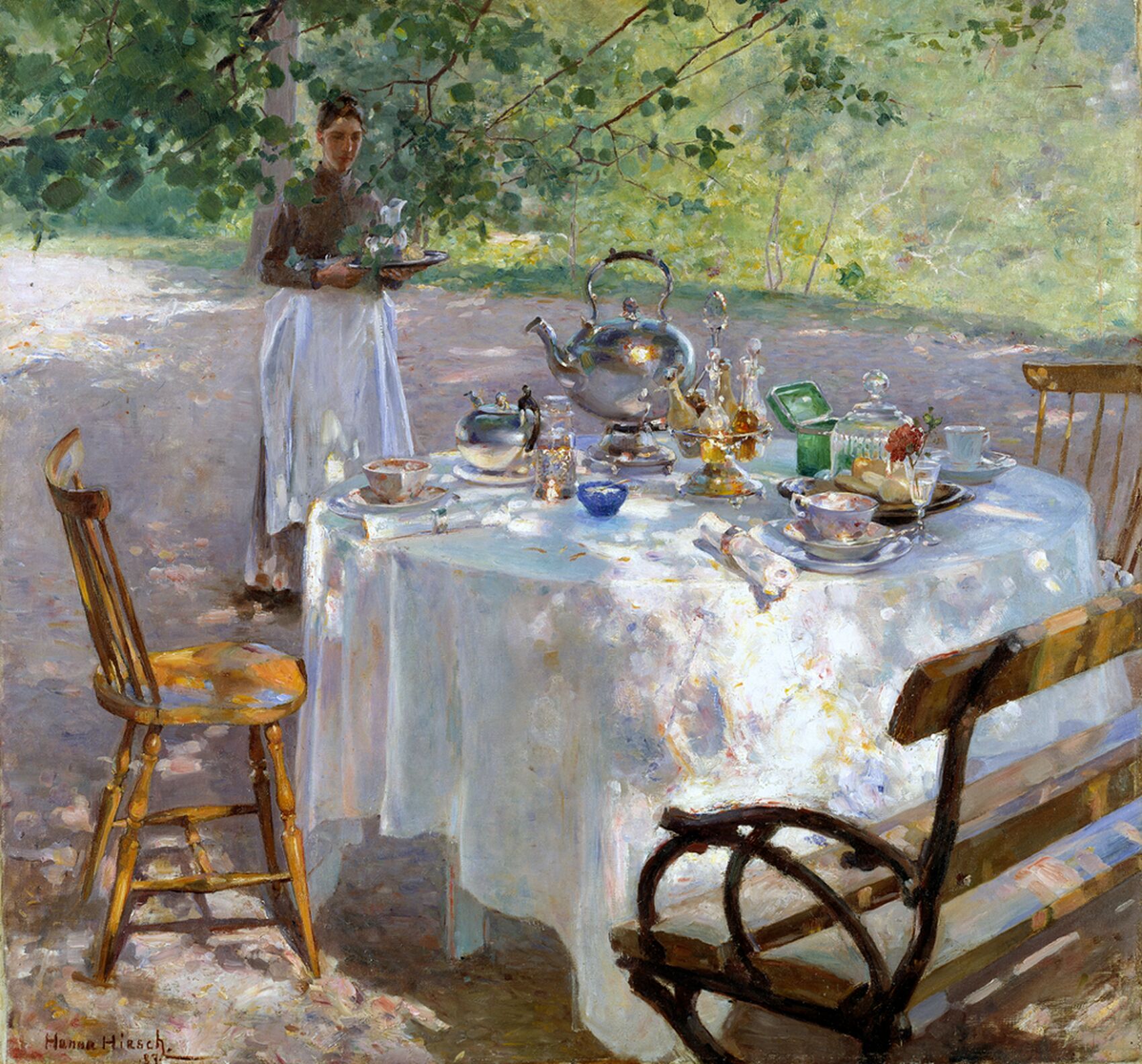 A table outside during summer time with a breakfast being served.