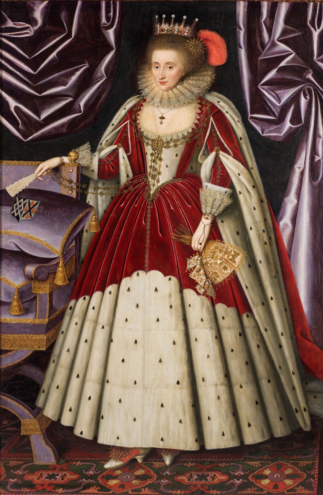 Oil painting portraing a woman standing in a dress from the 16th century in red and white with a crown.